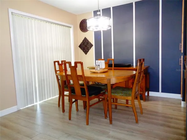 a view of a dining room with furniture and wooden floor