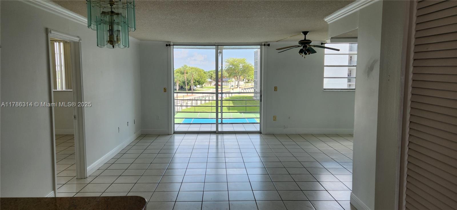 14195 Southwest 87th Street, Unit B306 Miami, FL 33183 - Photo 1 of 13 a view of an empty room with a window