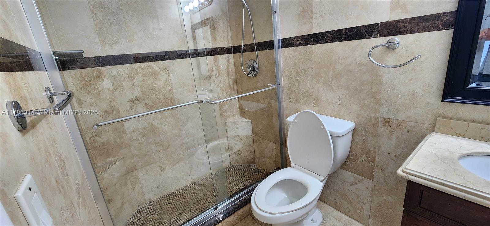 14195 Southwest 87th Street, Unit B306 Miami, FL 33183 - Photo 13 of 13 a white toilet sitting next to a shower