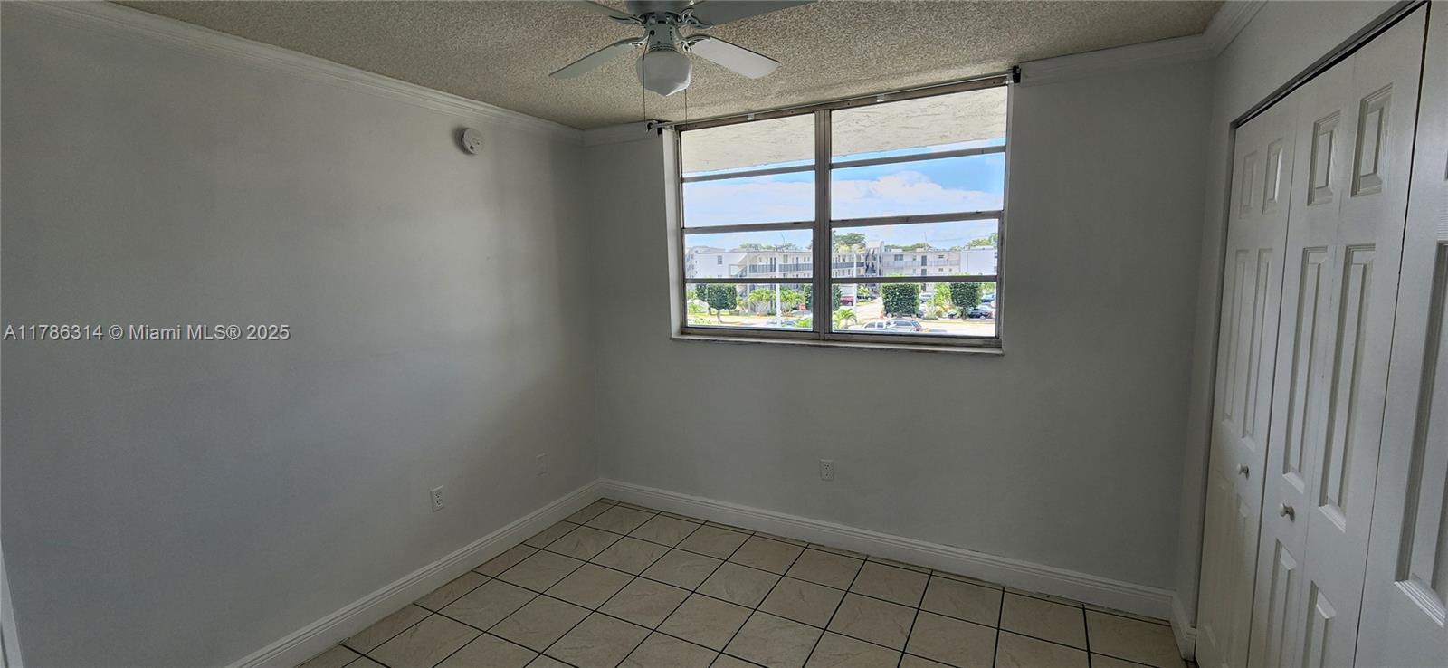 14195 Southwest 87th Street, Unit B306 Miami, FL 33183 - Photo 8 of 13 a view of an empty room with a window