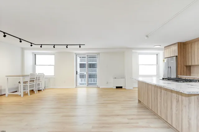a view of a kitchen with furniture and wooden floor