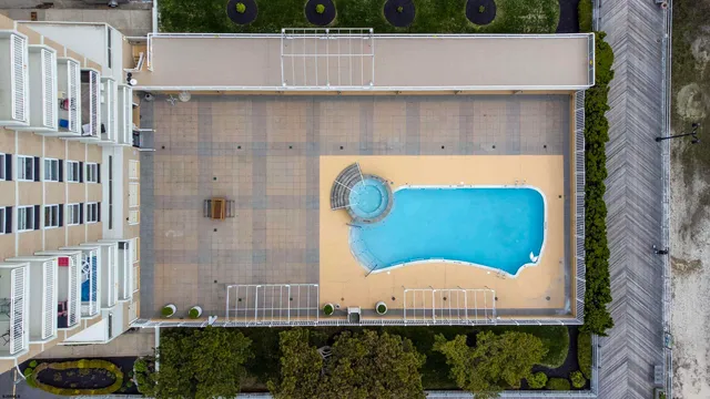 a view of a swimming pool with a lawn chairs