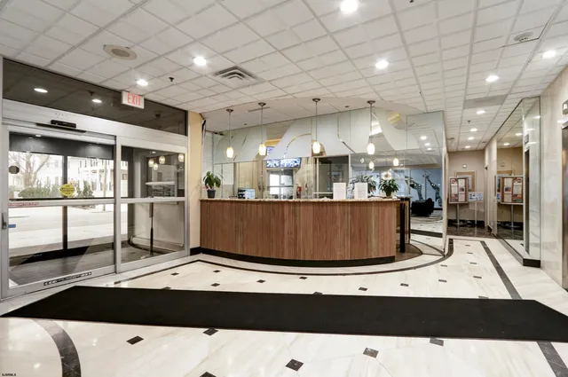 a living room with lots of furniture and a large window