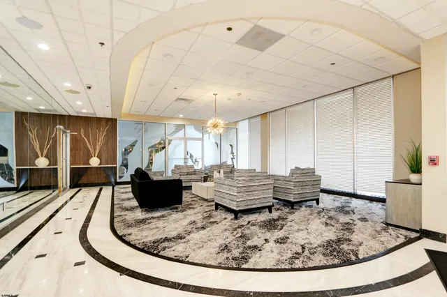 a view of a patio with table and chairs potted plants