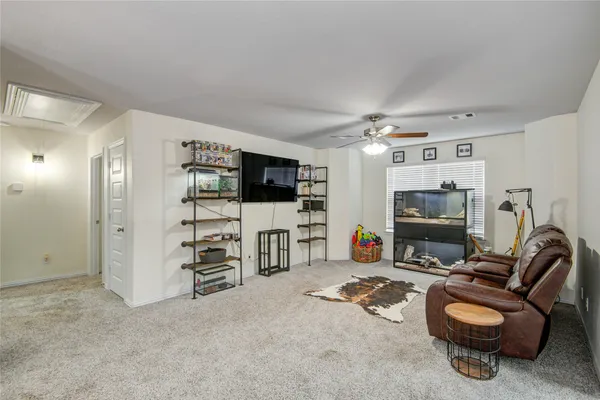 a view of a livingroom with furniture and a flat screen tv