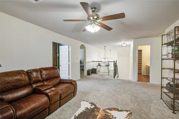 a living room with furniture and kitchen view