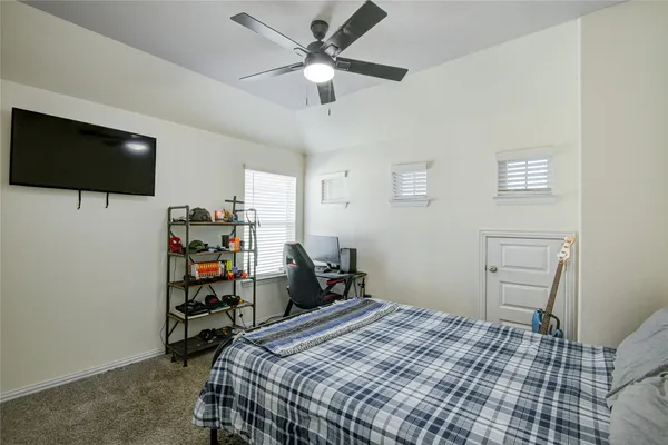 a bedroom with a bed and a flat screen tv