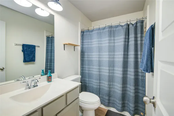 a bathroom with a sink toilet and mirror