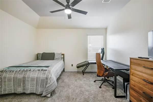 a bedroom with a bed and a desk