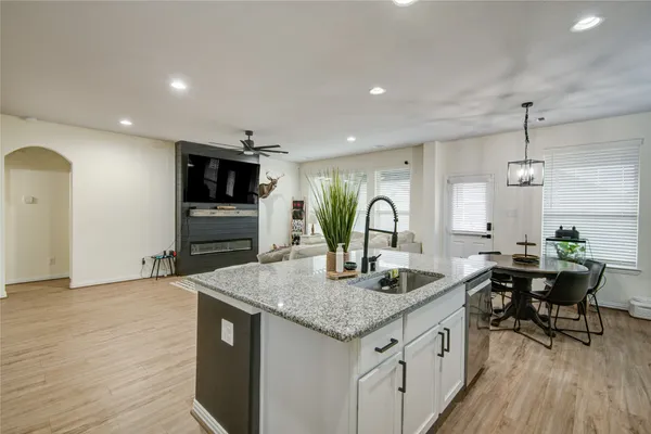 a kitchen with sink cabinets and wooden floor