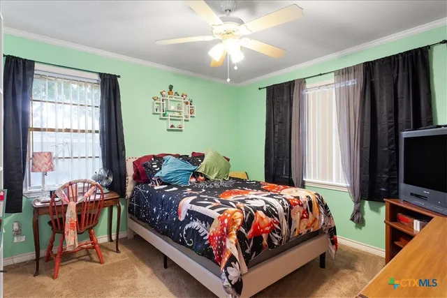 a bedroom with a bed and a tv