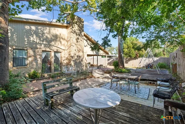 a view of a house with backyard and sitting area