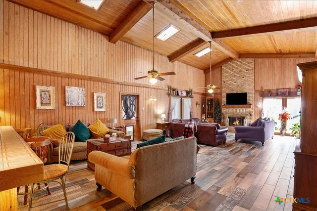 a living room with fireplace furniture and a window