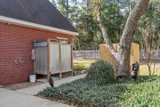 a view of a house with a yard and tree