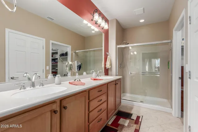 a bathroom with a double vanity sink mirror double and shower