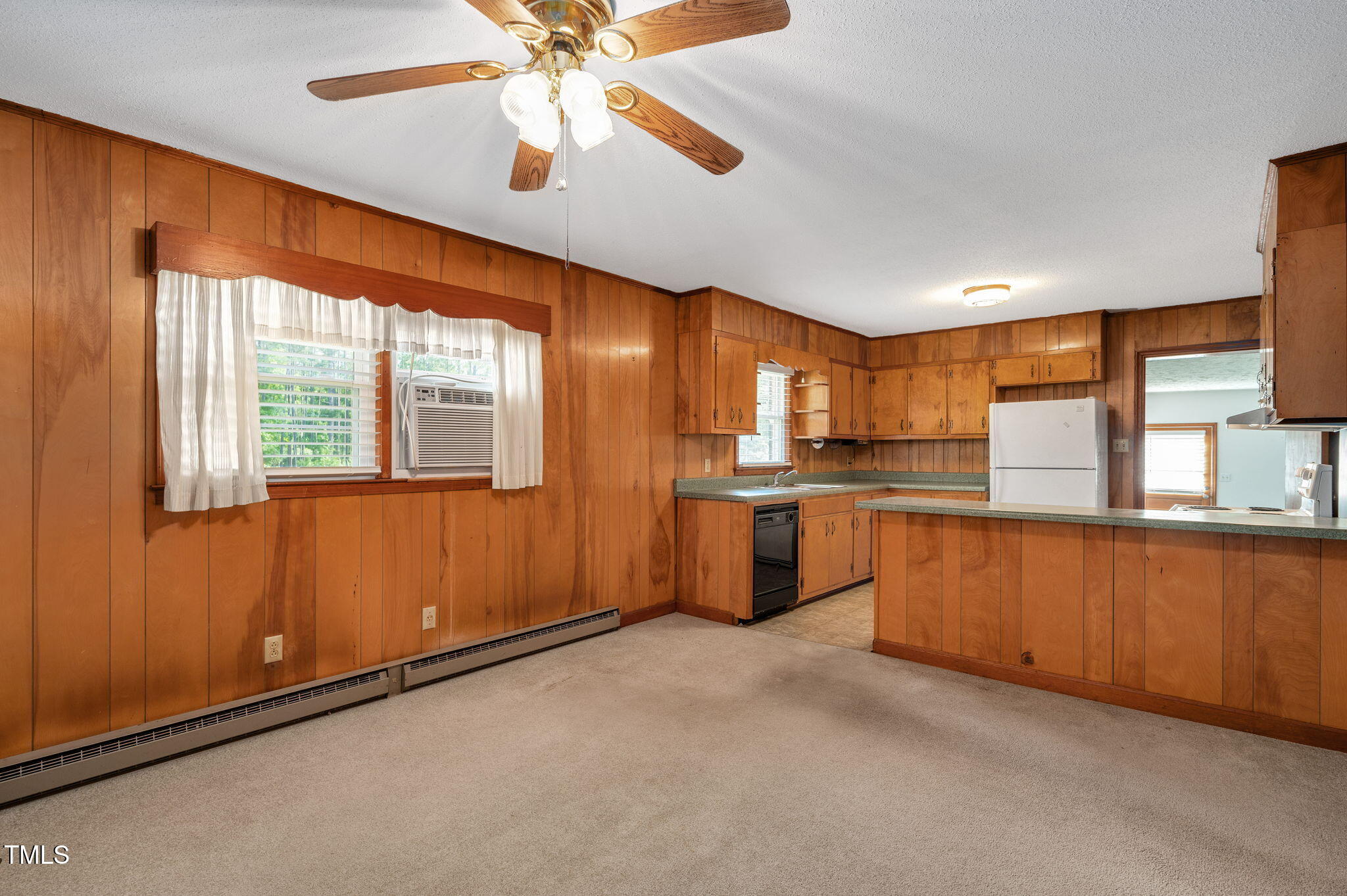 202 Hamilton Road Bunnlevel, NC 28323 - Photo 17 of 31 a kitchen with stainless steel appliances kitchen island granite countertop a refrigerator a sink dishwasher a stove and a dining table with wooden floor