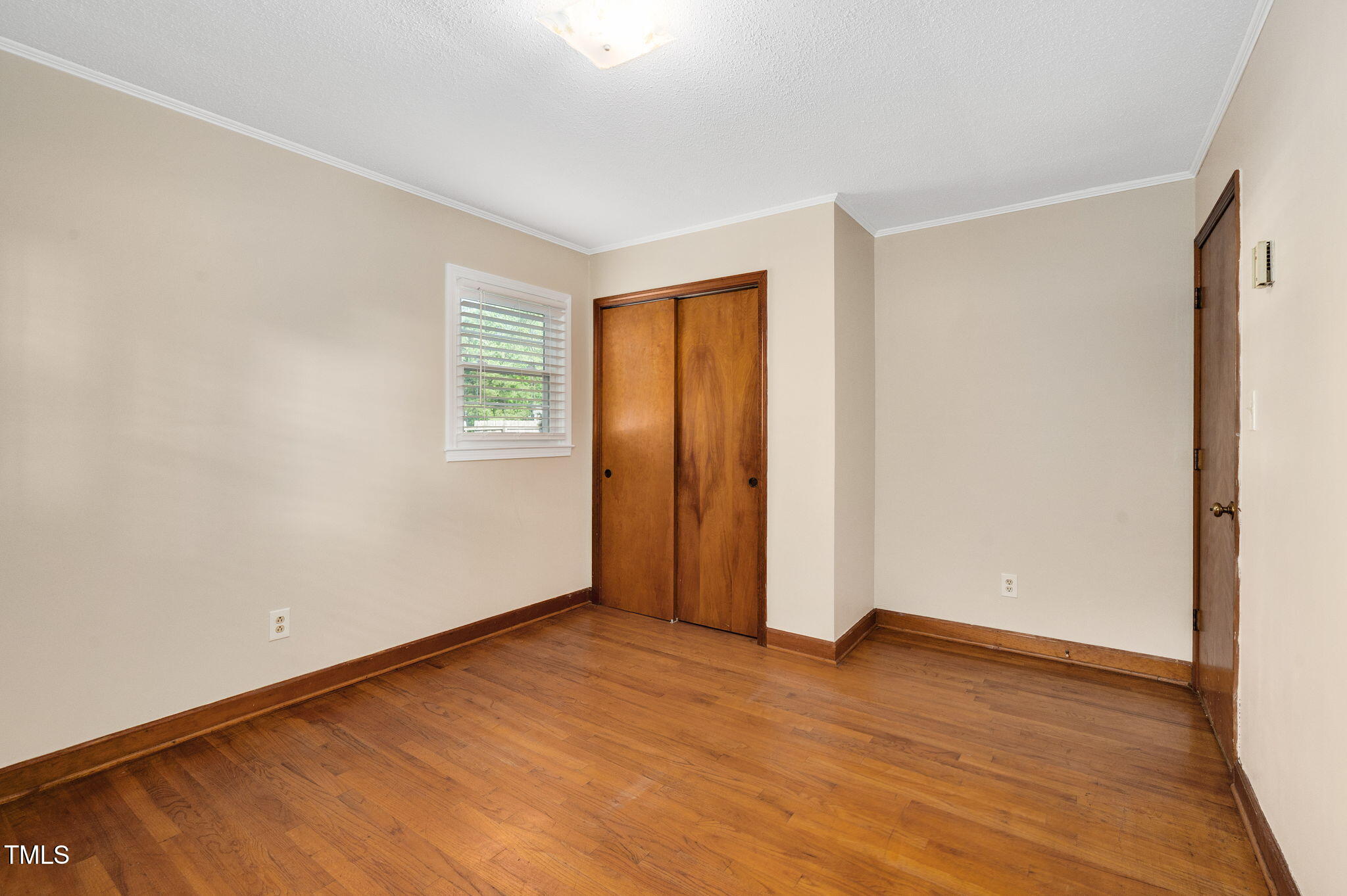 202 Hamilton Road Bunnlevel, NC 28323 - Photo 23 of 31 an empty room with wooden floor and windows