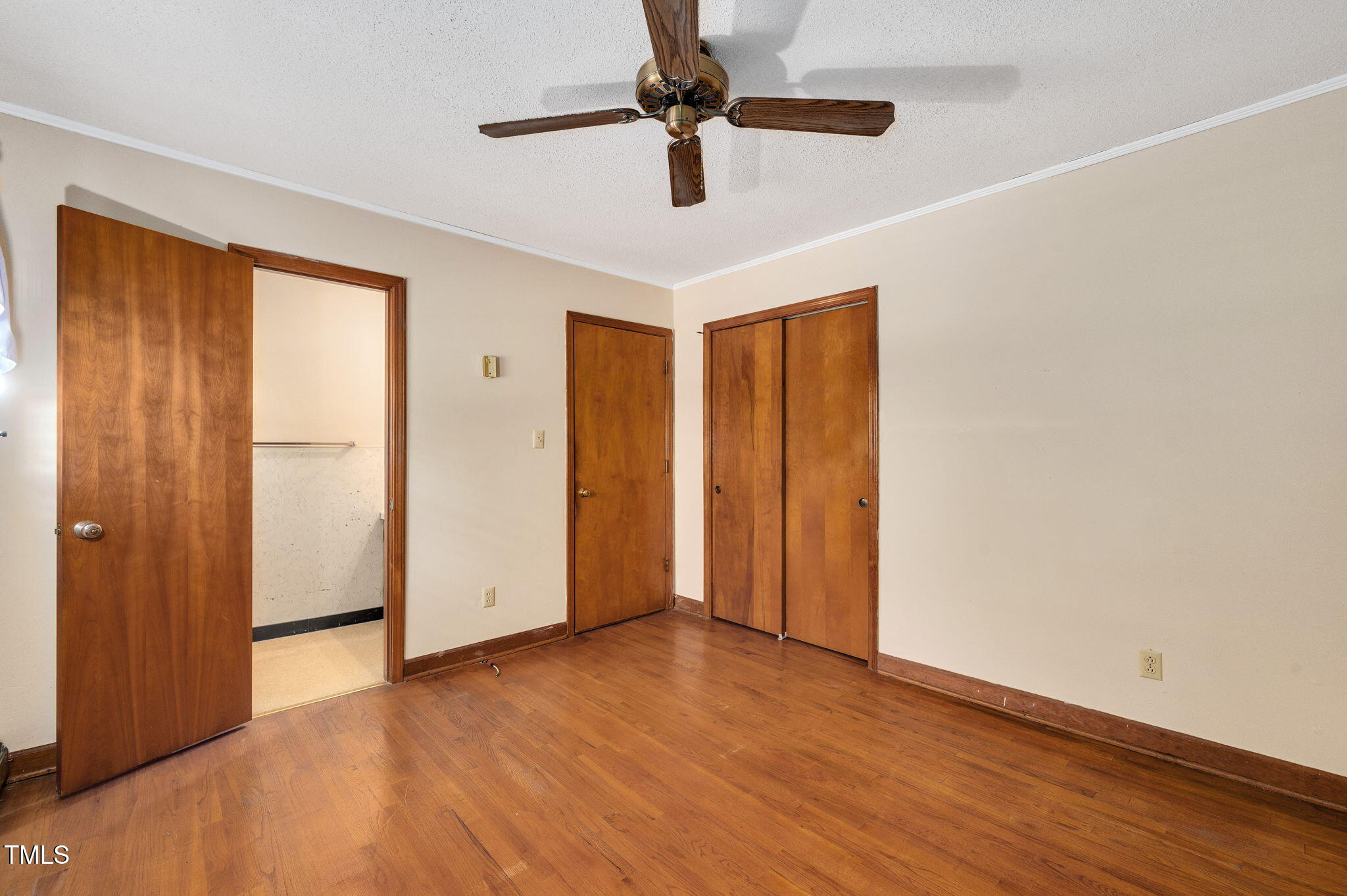 202 Hamilton Road Bunnlevel, NC 28323 - Photo 30 of 31 a view of an empty room with window a ceiling fan and wooden floor