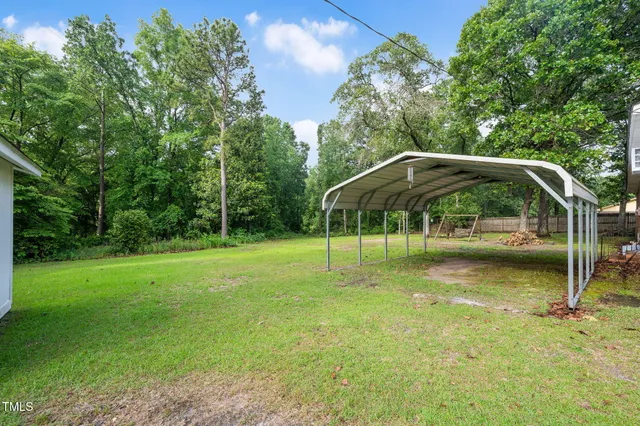 a backyard of a house with swing and slide