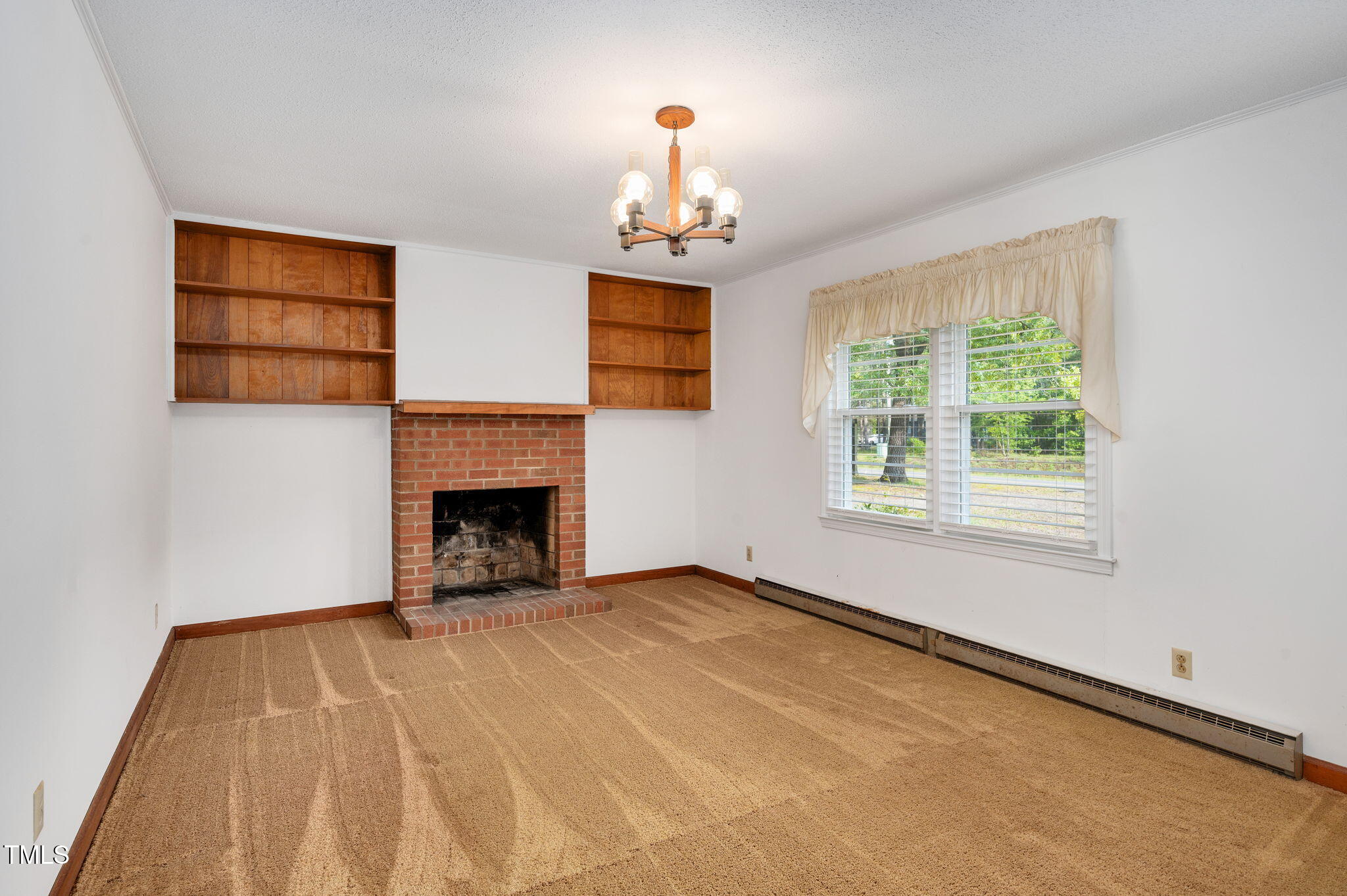 202 Hamilton Road Bunnlevel, NC 28323 - Photo 9 of 31 a view of an empty room with a fireplace and a window