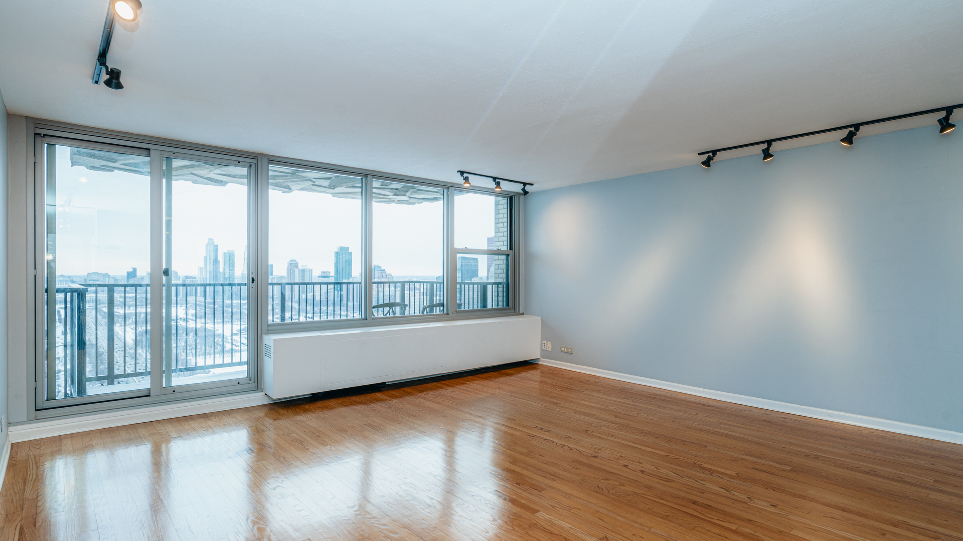 400 East Randolph Street, Unit 3915 Chicago, IL 60601 - Photo 2 of 16 wooden floor in an empty room with a window