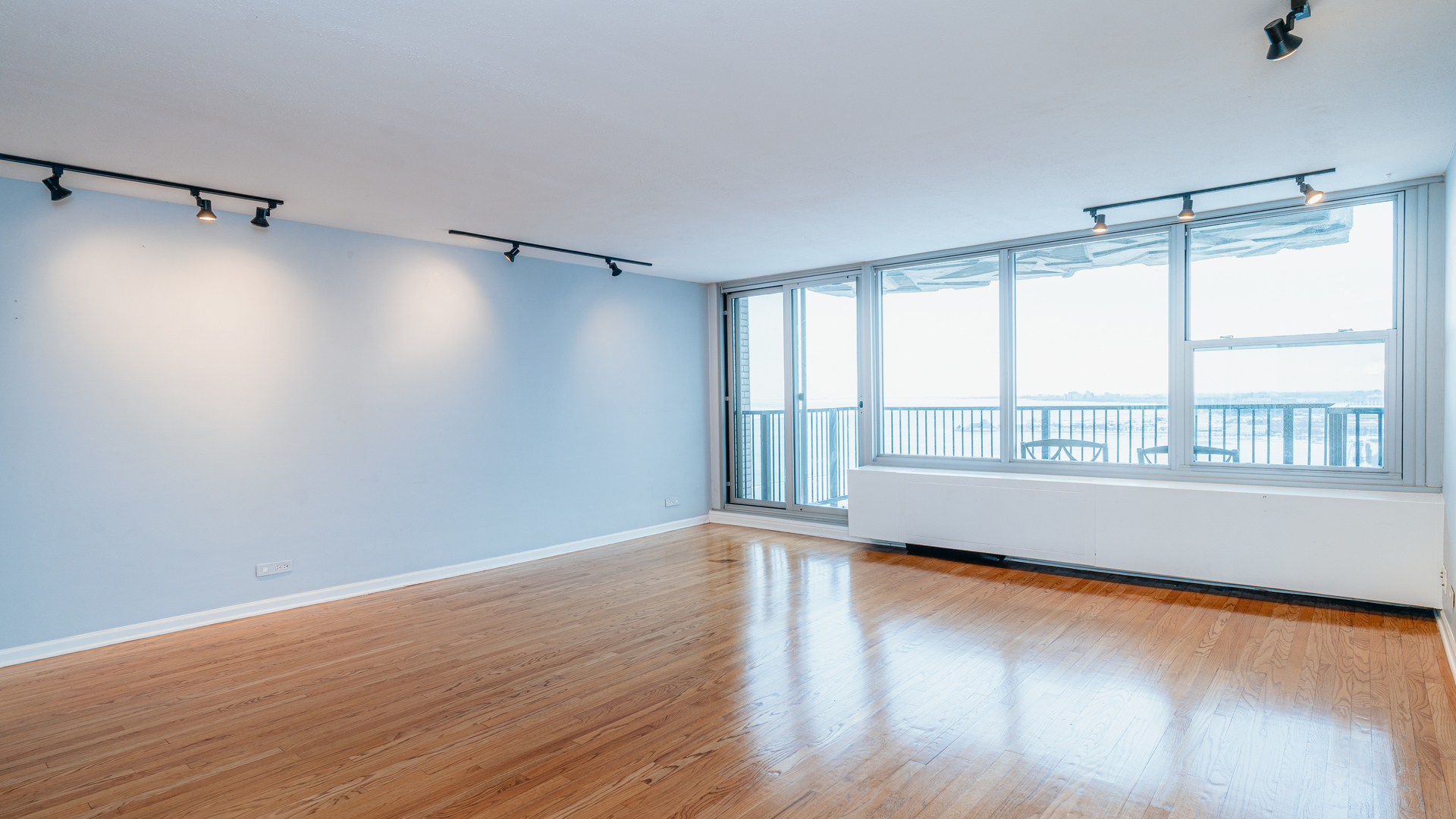 400 East Randolph Street, Unit 3915 Chicago, IL 60601 - Photo 3 of 16 a view of an empty room with wooden floor and a window