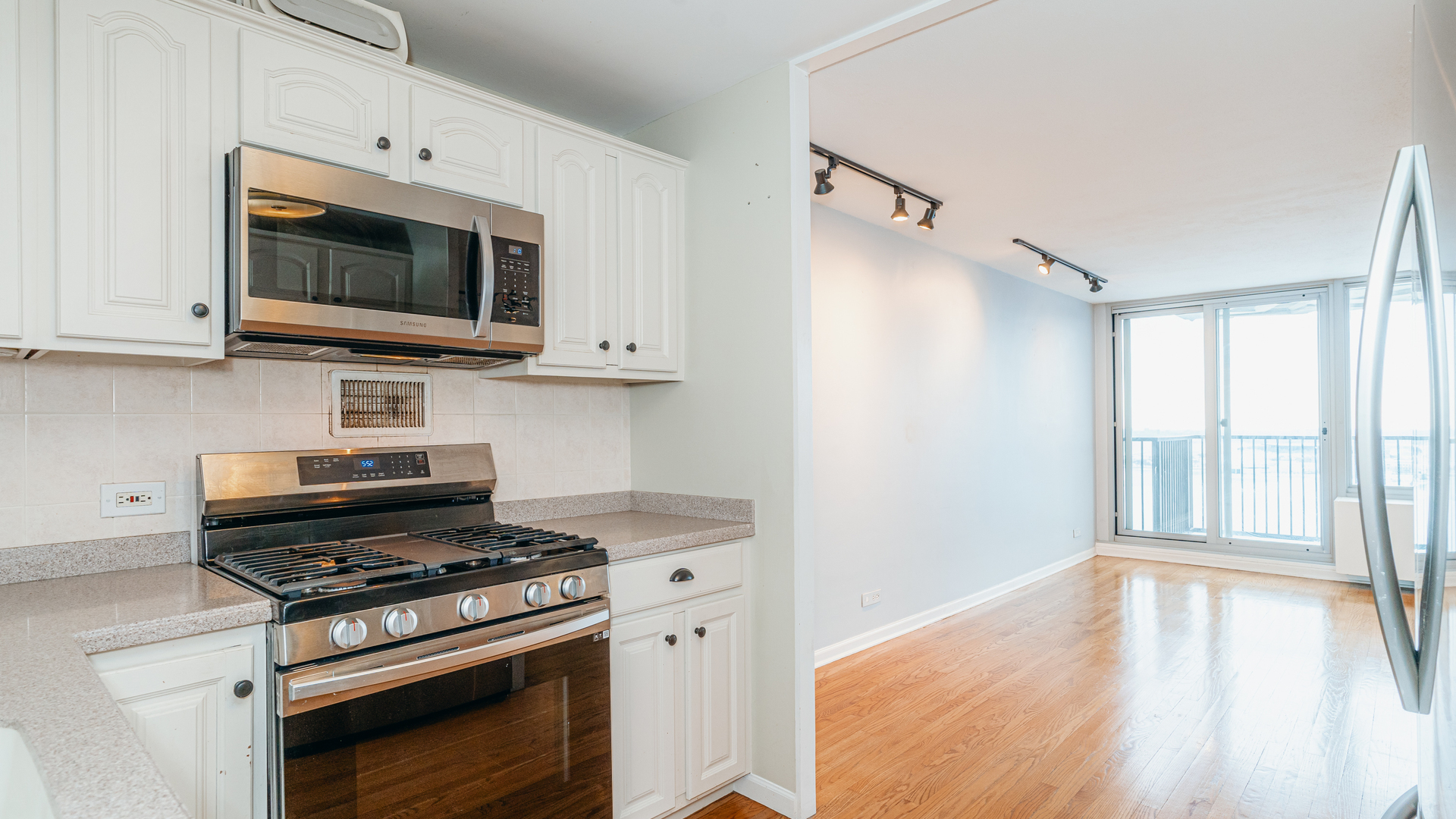 400 East Randolph Street, Unit 3915 Chicago, IL 60601 - Photo 5 of 16 a kitchen with a stove and a microwave