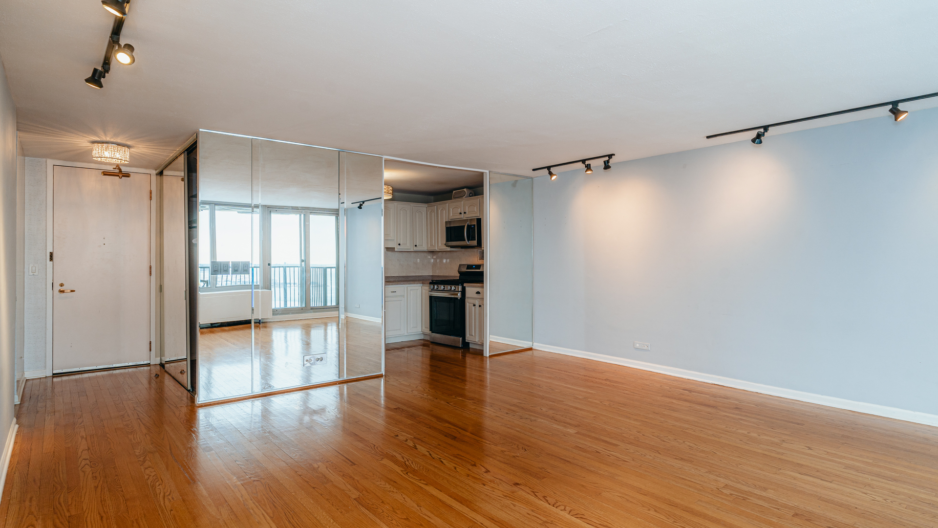 400 East Randolph Street, Unit 3915 Chicago, IL 60601 - Photo 6 of 16 a view of empty room with wooden floor and window