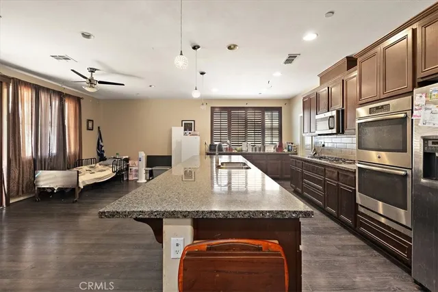 a kitchen with stainless steel appliances granite countertop a stove and a sink