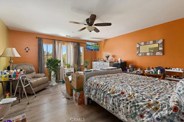 a bedroom with a bed couch and a window