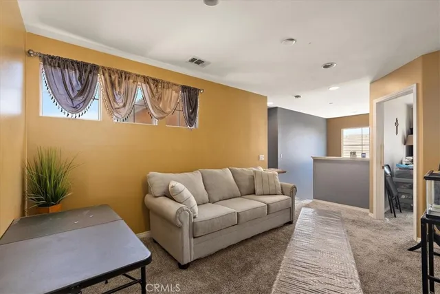 a living room with furniture and a rug