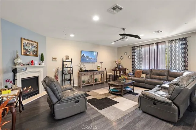 a living room with furniture kitchen view and a fireplace