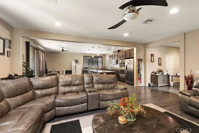 a living room with furniture and kitchen view