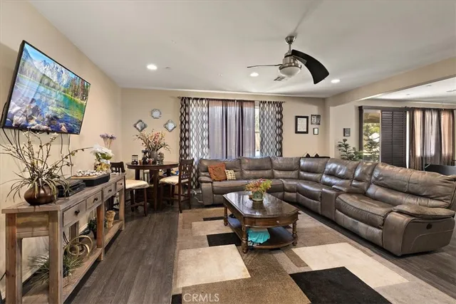 a living room with furniture a rug and a flat screen tv
