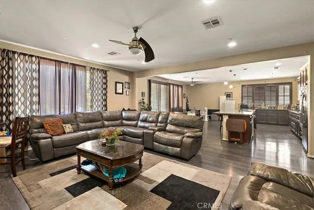 a living room with furniture potted plant and a large window
