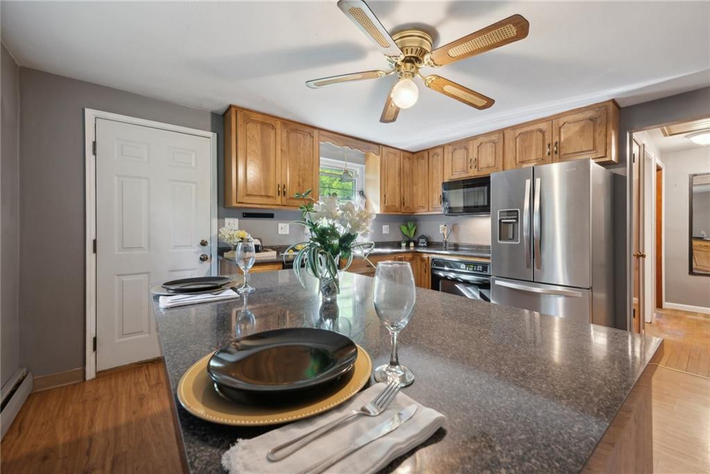 2074 Monroeville Road Monroeville, PA 15146 - Photo 13 of 26 a kitchen with sink a refrigerator and chairs