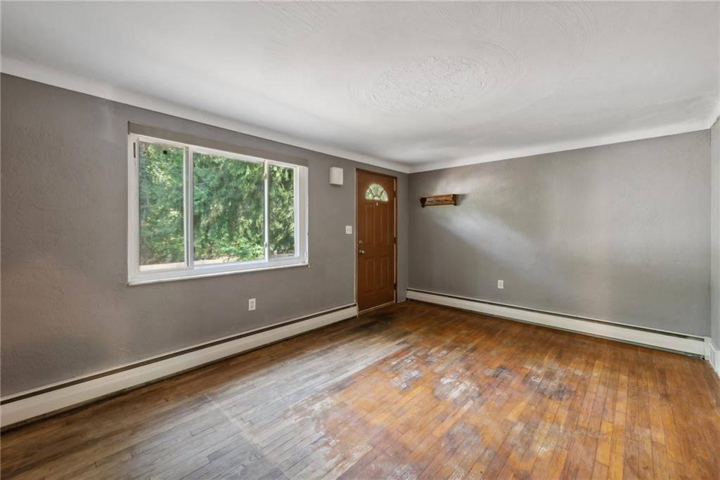 2074 Monroeville Road Monroeville, PA 15146 - Photo 9 of 26 an empty room with wooden floor and windows