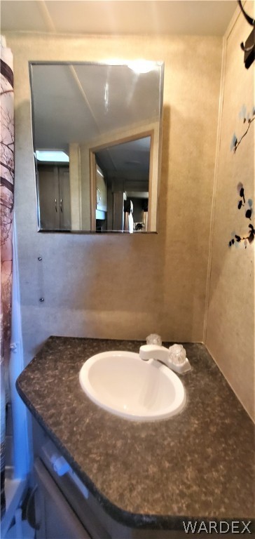 611 Bacobi Road Golden Valley, AZ 86413 - Photo 68 of 83 a bathroom with a granite countertop sink and a mirror