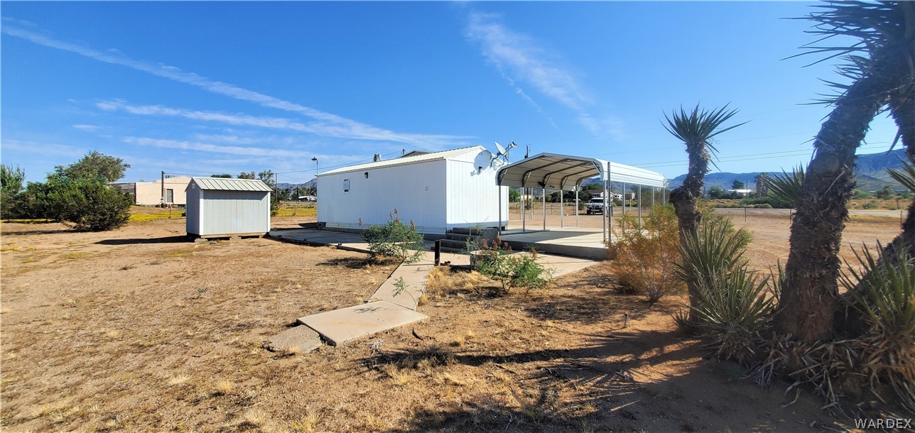611 Bacobi Road Golden Valley, AZ 86413 - Photo 8 of 83 a view of a house with backyard and trees
