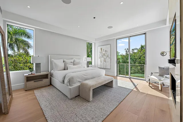 a bedroom with a bed and large window