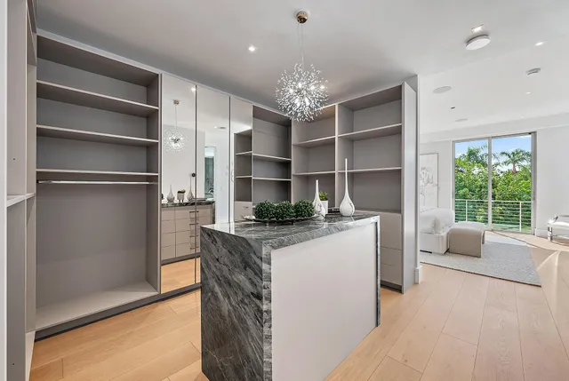 a kitchen with stainless steel appliances kitchen island granite countertop a refrigerator and a stove top oven