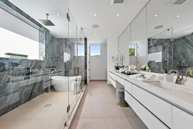 a large white kitchen with a large window