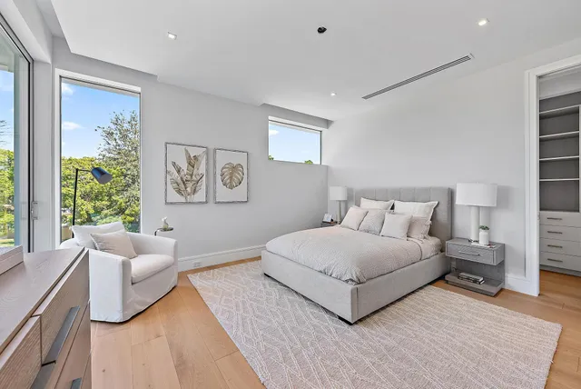 a spacious bedroom with a bed and a couch