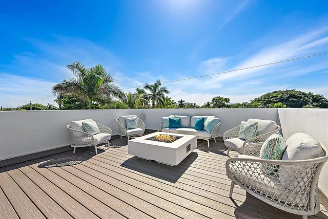 a outdoor sitting area with furniture and a potted plant