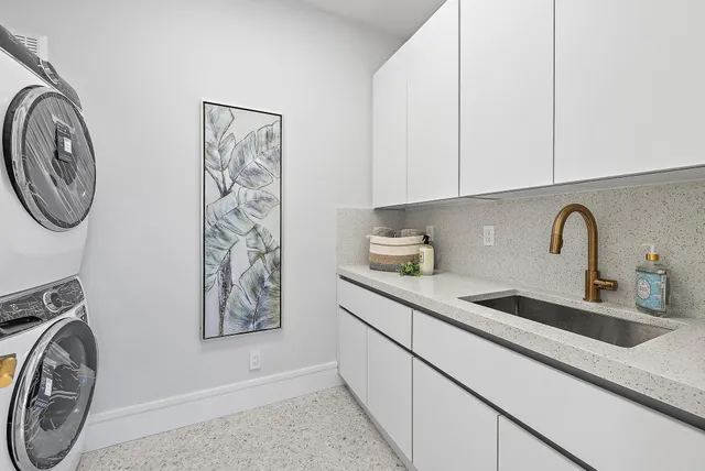 a kitchen with stainless steel appliances a sink a stove and cabinets