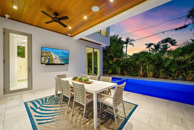 a view of a dining table and chairs in the patio