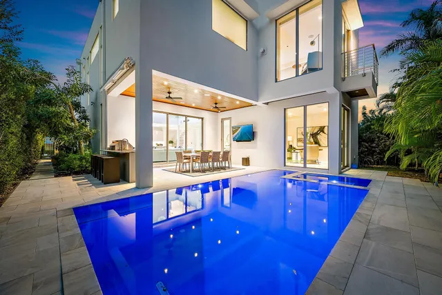 a swimming pool with outdoor seating and yard