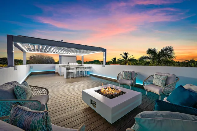 a roof deck with table and chairs