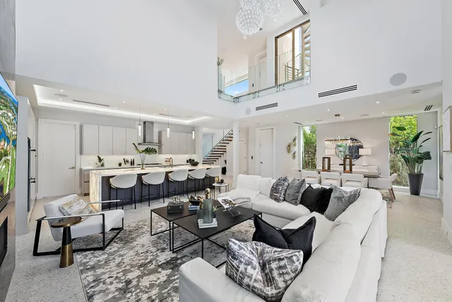 a living room with furniture and view of kitchen