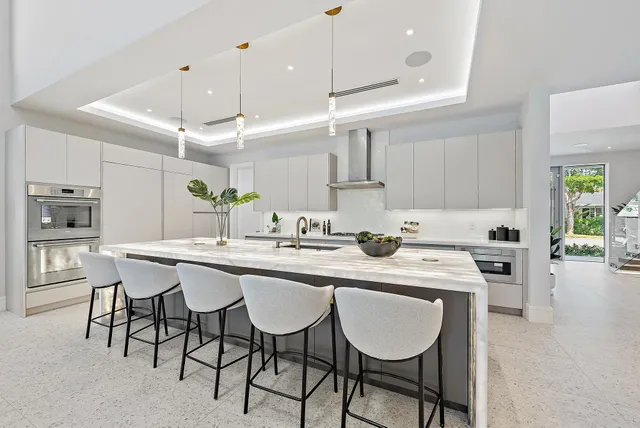 a kitchen with a dining table chairs sink and cabinets
